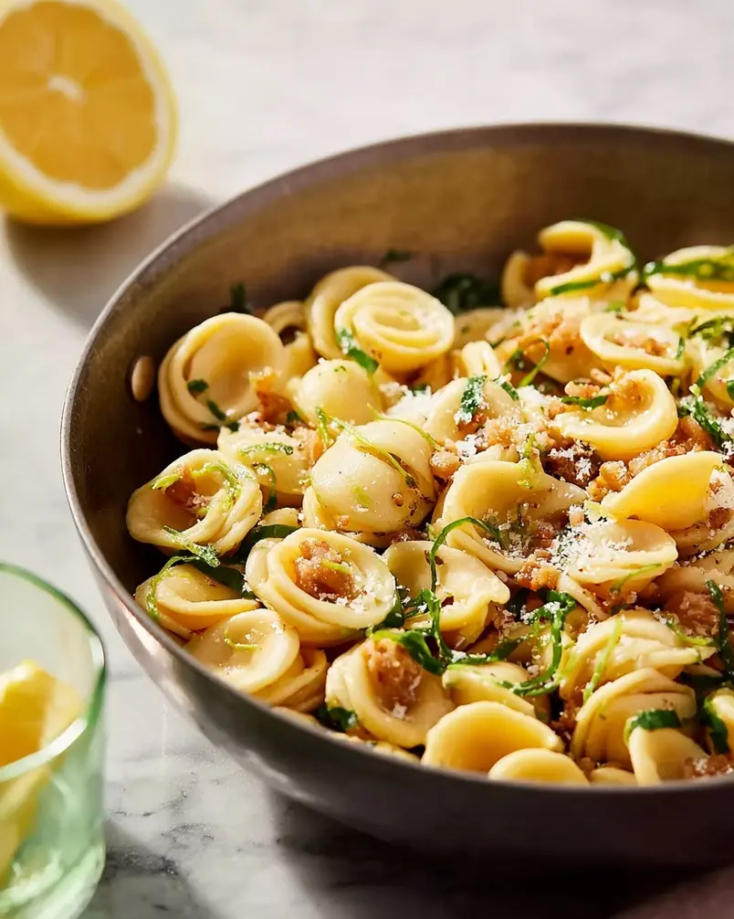 One Pan Orecchiette Pasta 3 Sausage browning in a pan with cherry tomatoes and garlic, starting the flavor base for the one pan orecchiette pasta.